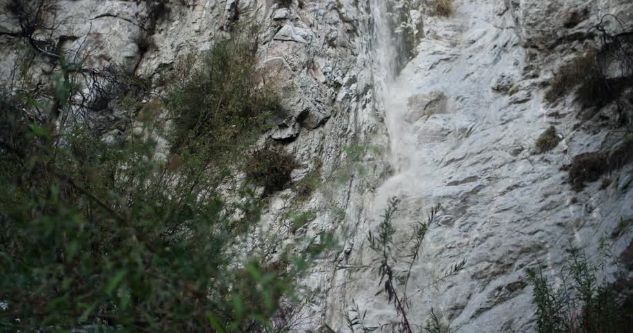 Water flows down a cliff in the wilderness