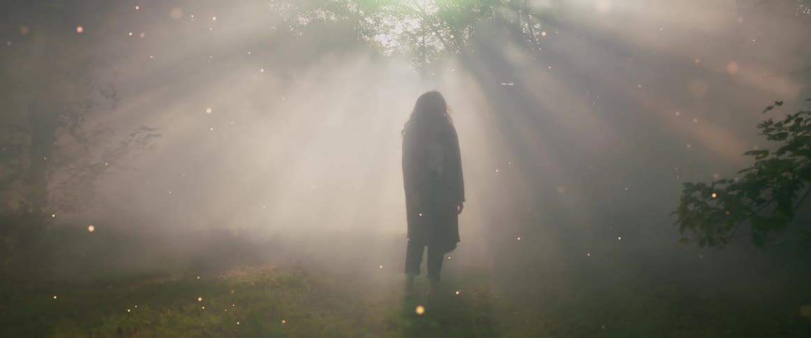 A person walks in the wilderness at sunrise