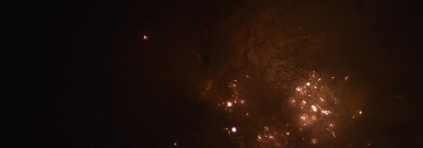 Balls of light sparking and floating up from water