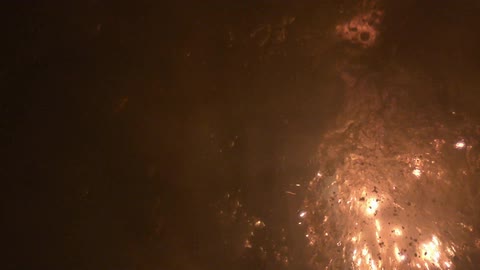 Sparks flying from an explosion underwater