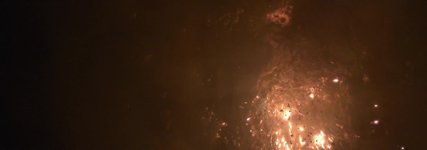 Sparks flying from an explosion underwater