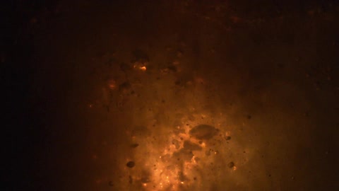 An explosion and sparks underwater in the dark