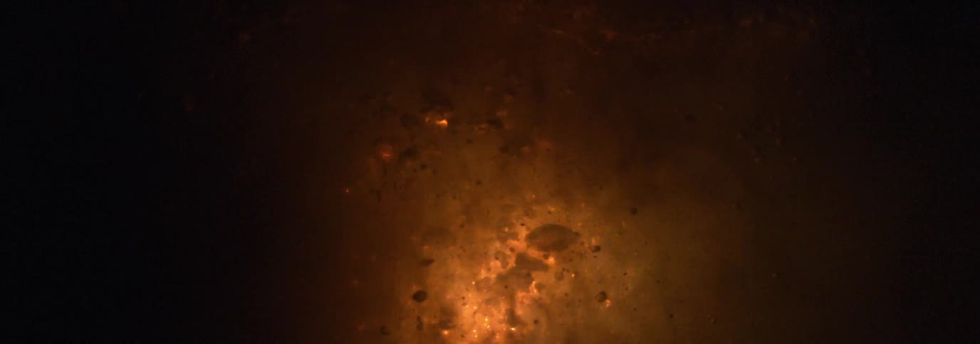 An explosion and sparks underwater in the dark