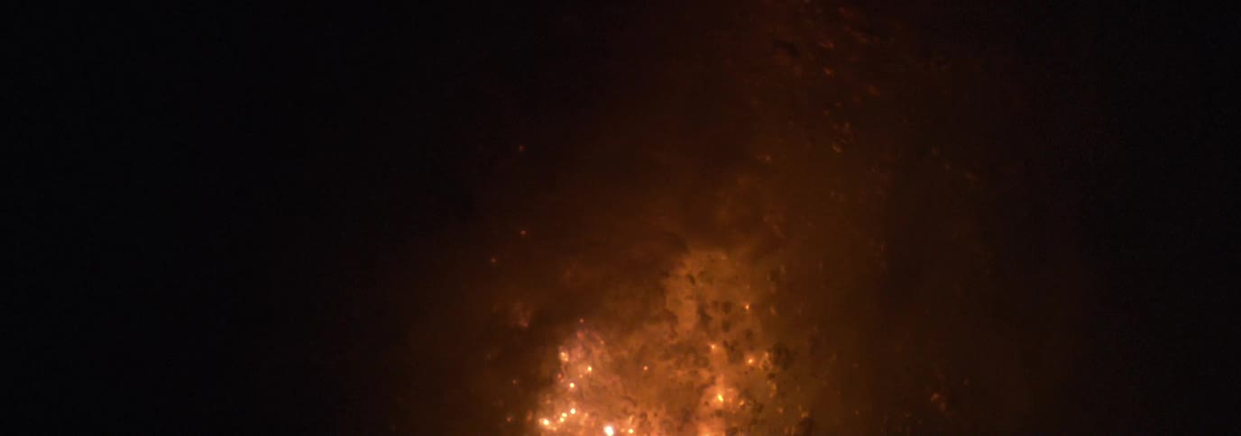 Surface of bubbling liquid brightens and darkens from within