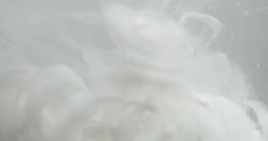 White liquid drops into clear liquid