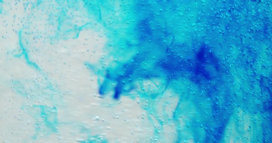 Blue liquid mixing with a bubble, clear liquid