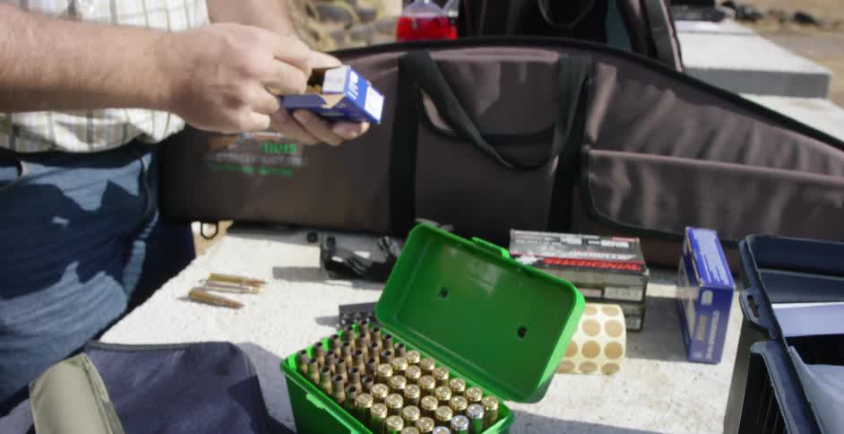 Person inspecting ammunition from a box