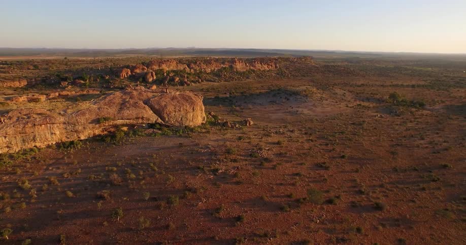 A large flat plain with rocky hills