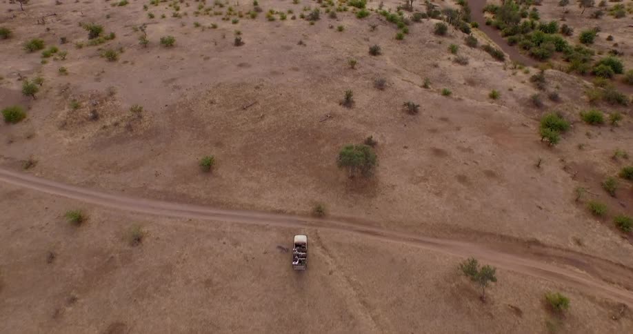 Aerial view of a jeep driving through the desert