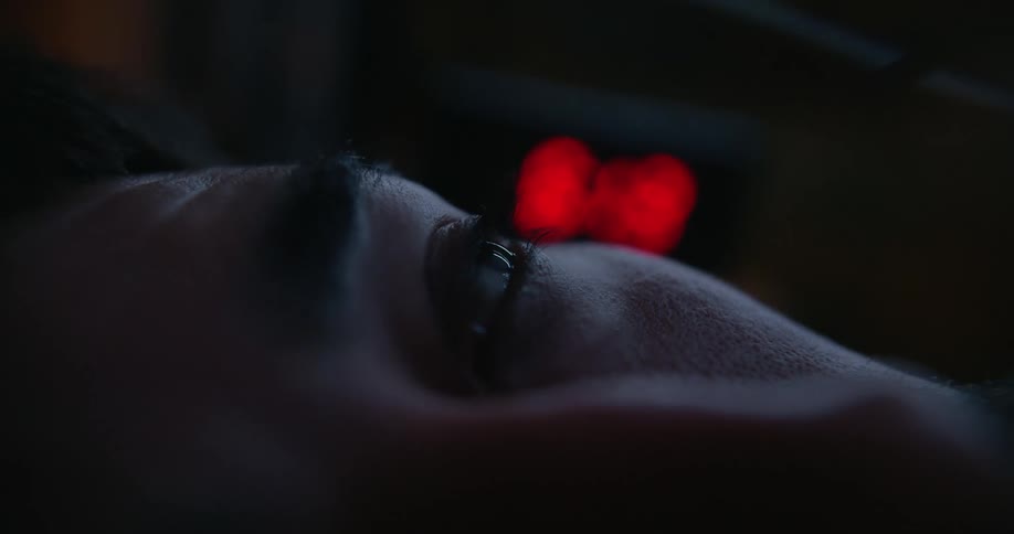 Close up view of a man resting at night is displayed