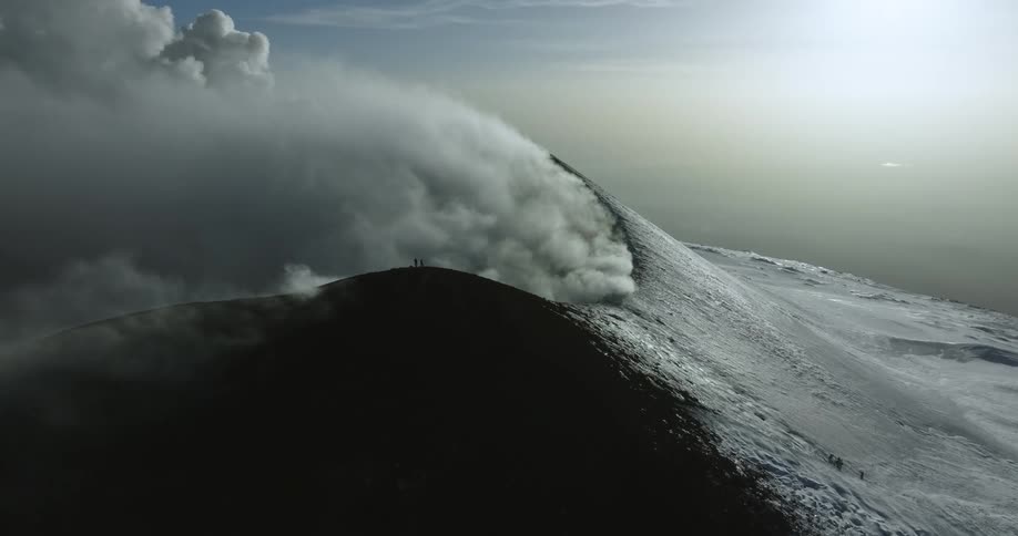Aerial view of a volcano is displayed at dusk