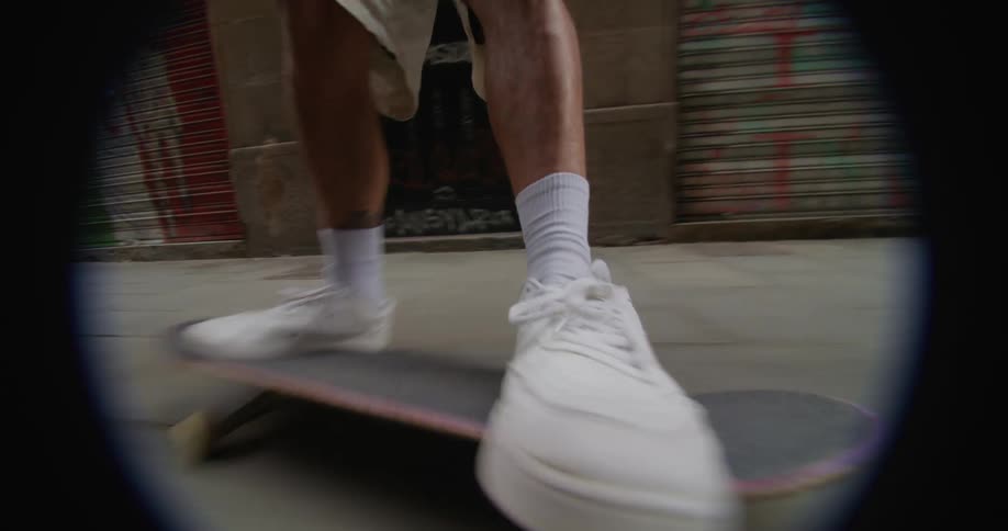 Skateboarder does trick skateboarding down the street in the city