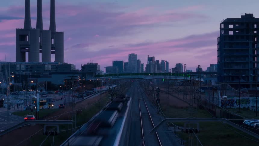 Trains and vehicles drive through the city