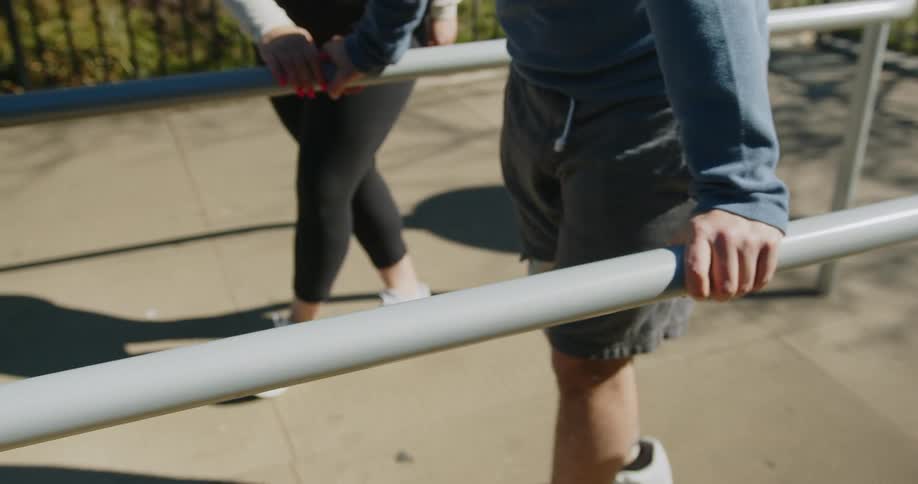 A physical therapist guiding a man with a prosthetic leg through walking exercises