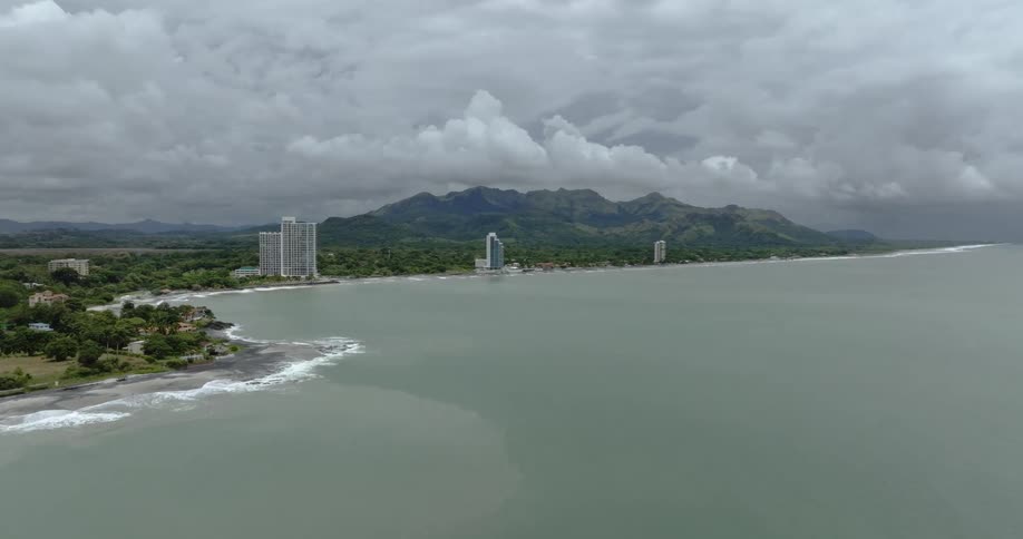Aerial view of south american coastline few buildings mountains in the background
