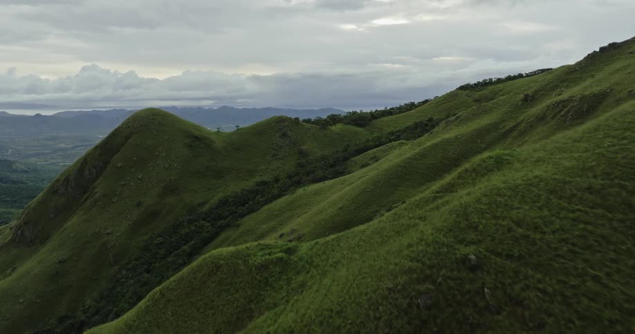 Aerial view of green mountain slope on a cloudy day