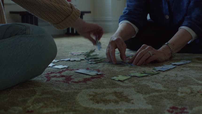 Two friends are playing a puzzle together indoors