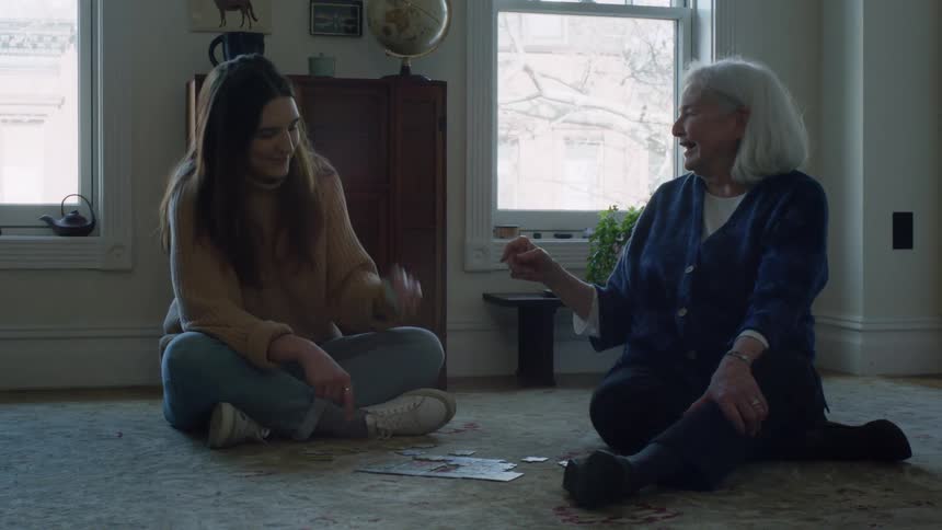 Two women talk and put a puzzle together