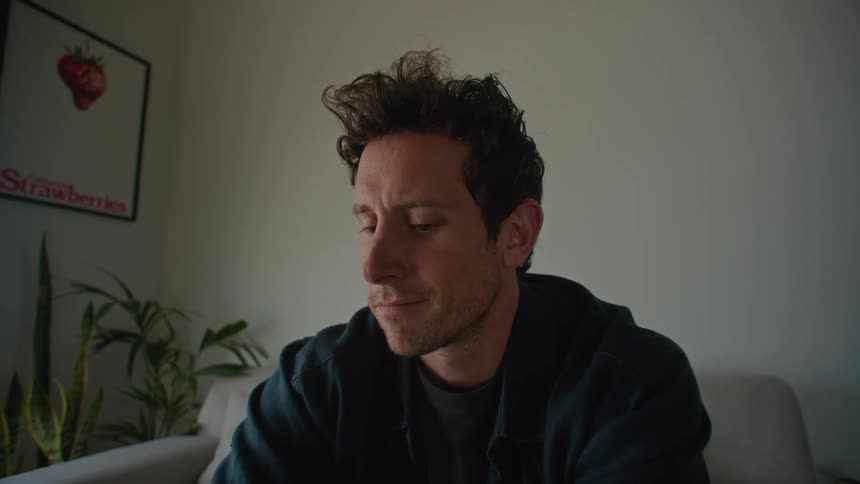 Idea occurs to man while typing on laptop in the living room at home