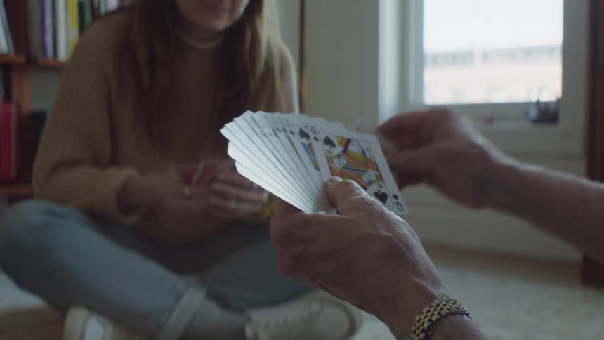 Two women are playing a card game together