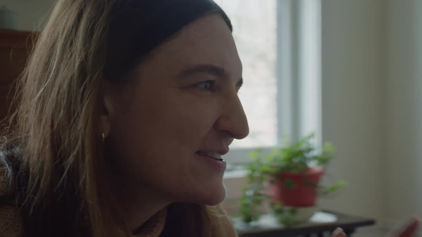 A young woman in talking inside of her home