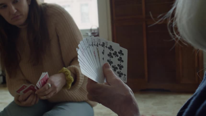 Two females are playing a game of cards together