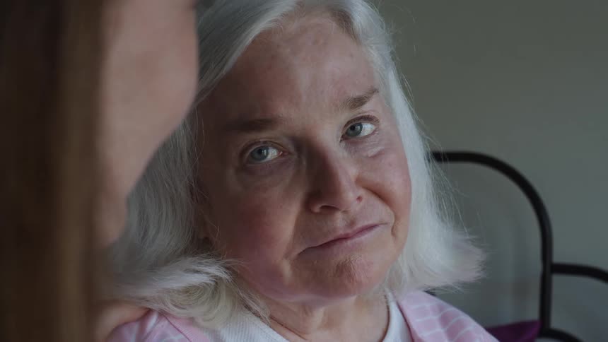 An older woman and her daughter talking