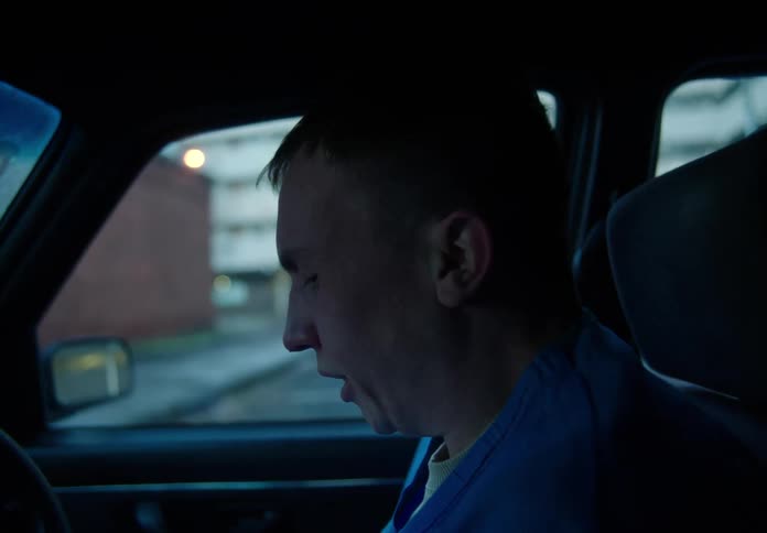 Close up of a young male nurse entering a car having a nervous breakdown outside the hospital