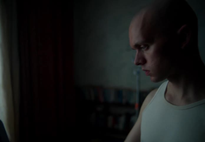 The view is of a young man that is inside of his home