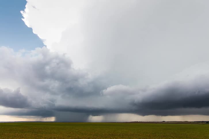 Timelapse of a storm clouds developing over a wide open grassland