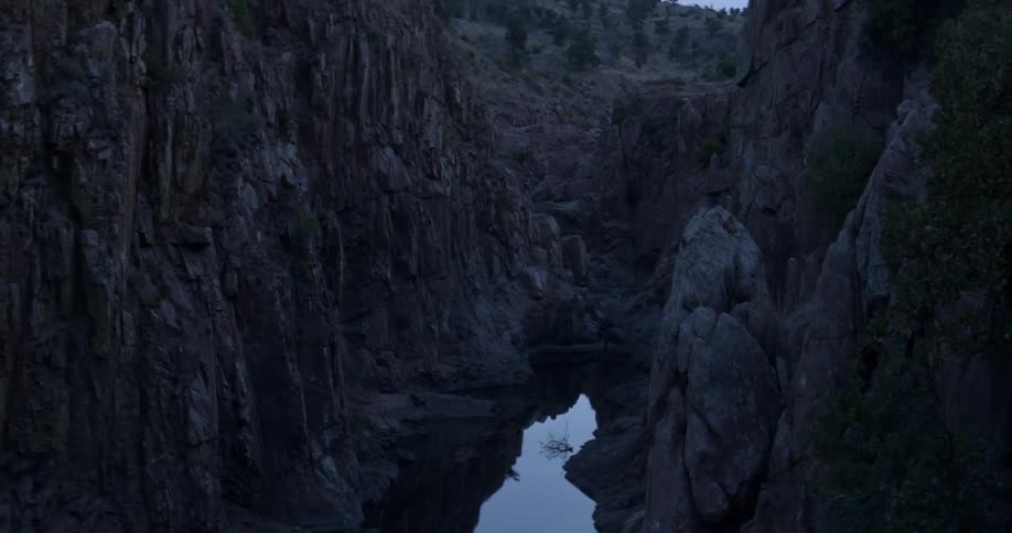 The small pool of water meets the canyons ahead