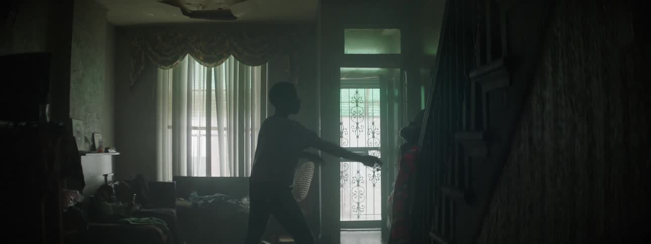 Boy comes into house and pushes a woman before going upstairs