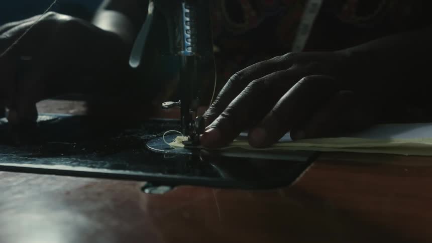 A shot of a woman using a sewing machine