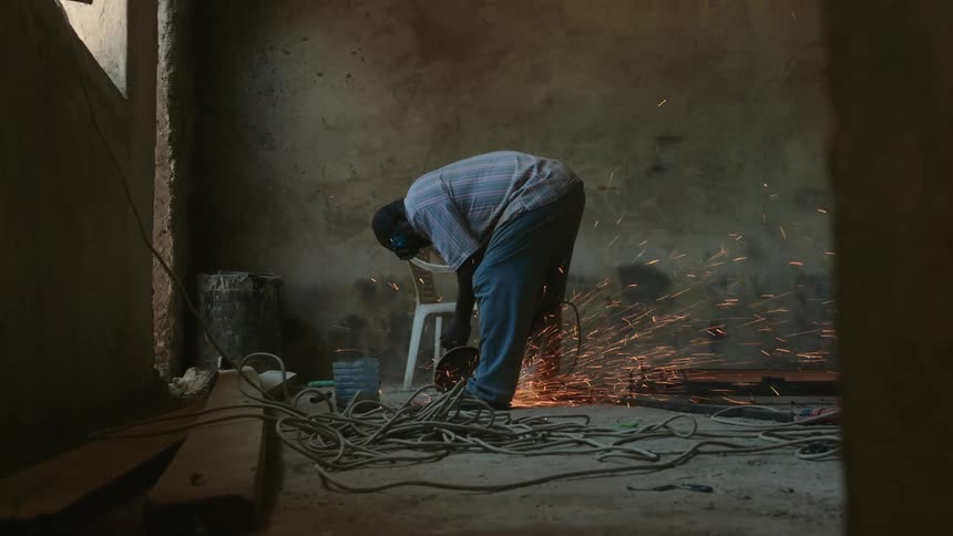 An electrician works in a building under construction