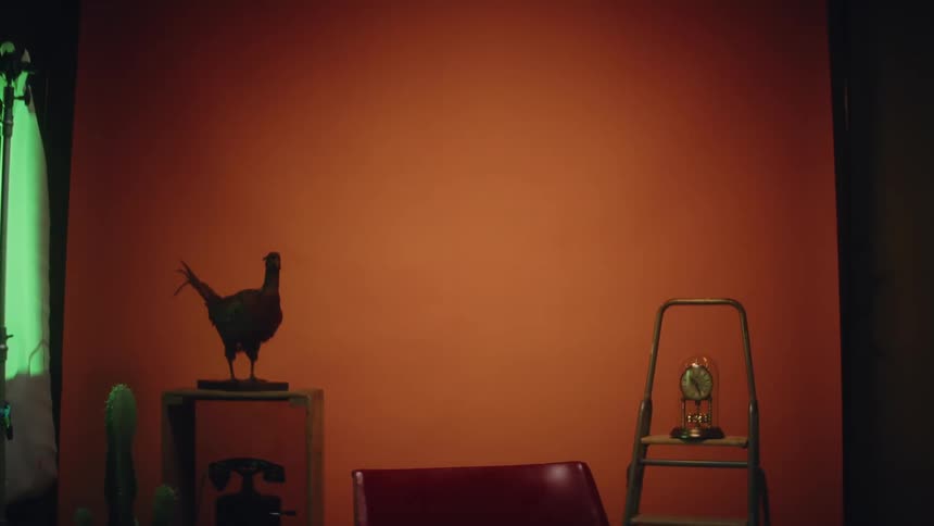 A woman is standing in a room and walking away