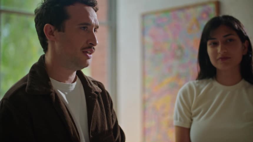Two women talking and looking at a man and also talking to him and nodding their heads