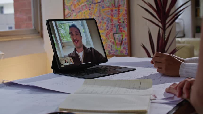 People are video chatting with someone on a laptop