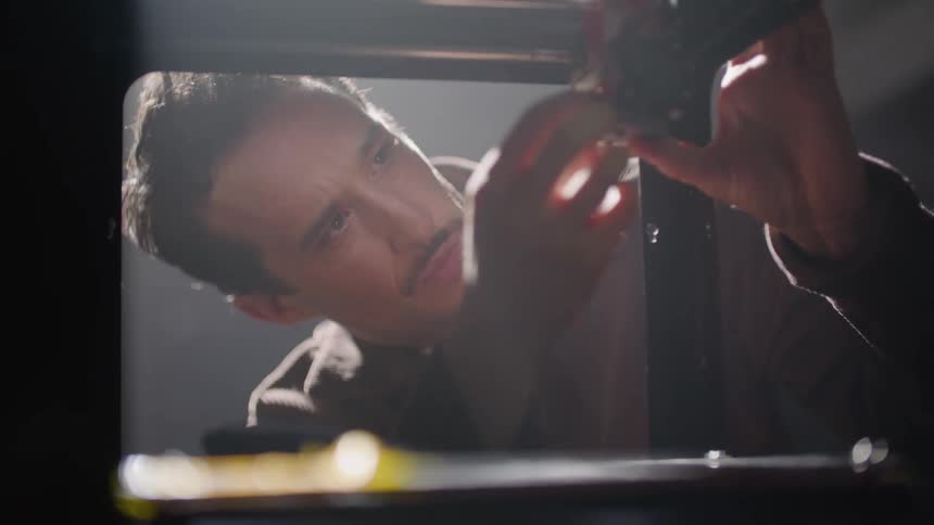 Man bends while adjusting joint of machine