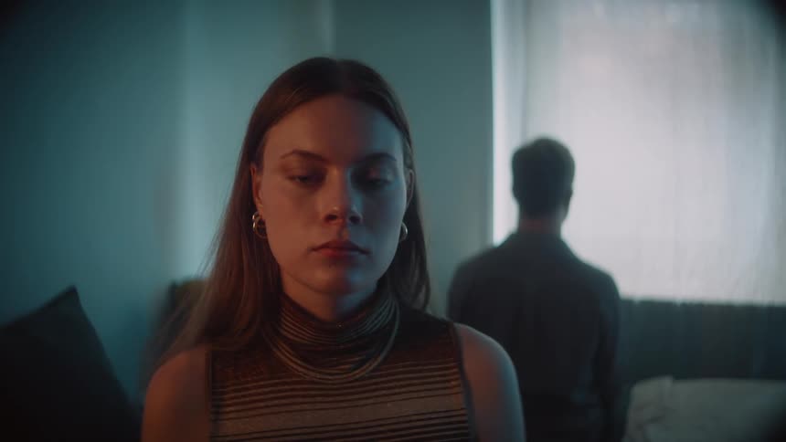 Two people are indoors and they looks like they are sad