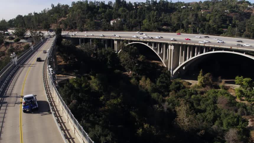 The view is of the downtown area and cars are driving down the highway