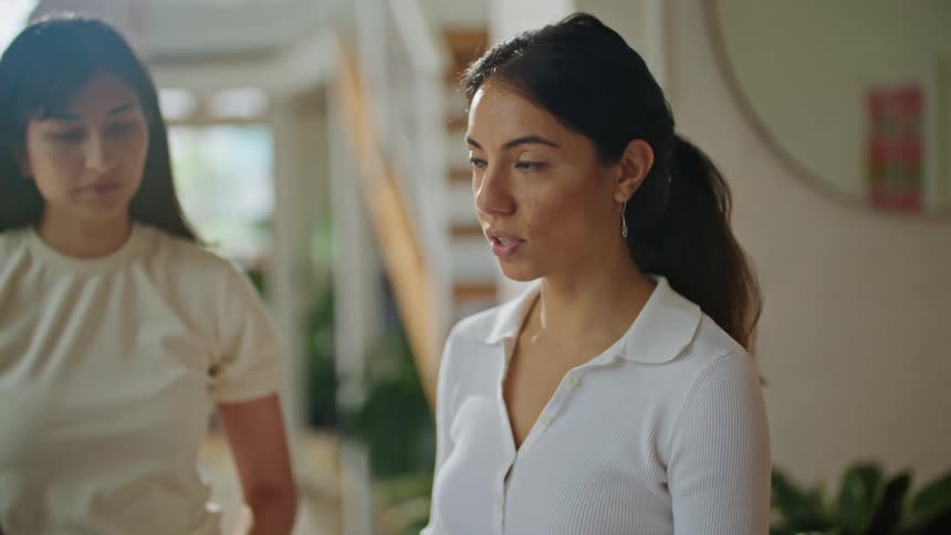 Women in white shirts and man with brown jacket working on reports