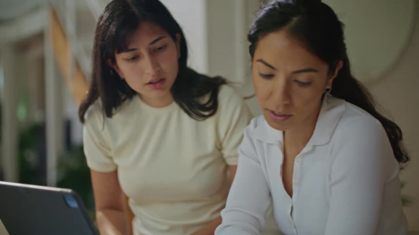 Women with white shirts use tablet and works on workpapers