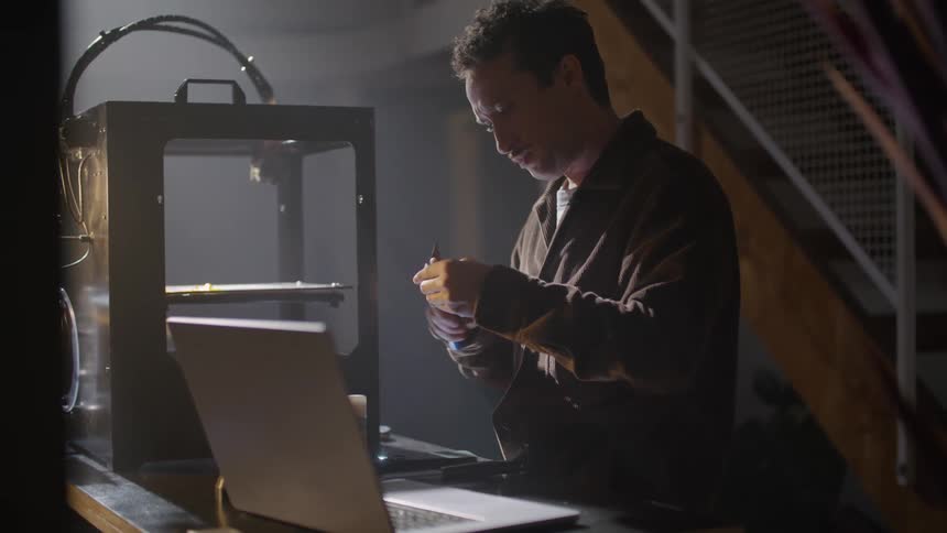 The view is of a young man working on something inside of his home