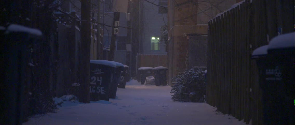 View of garbage bins in a snowy alley