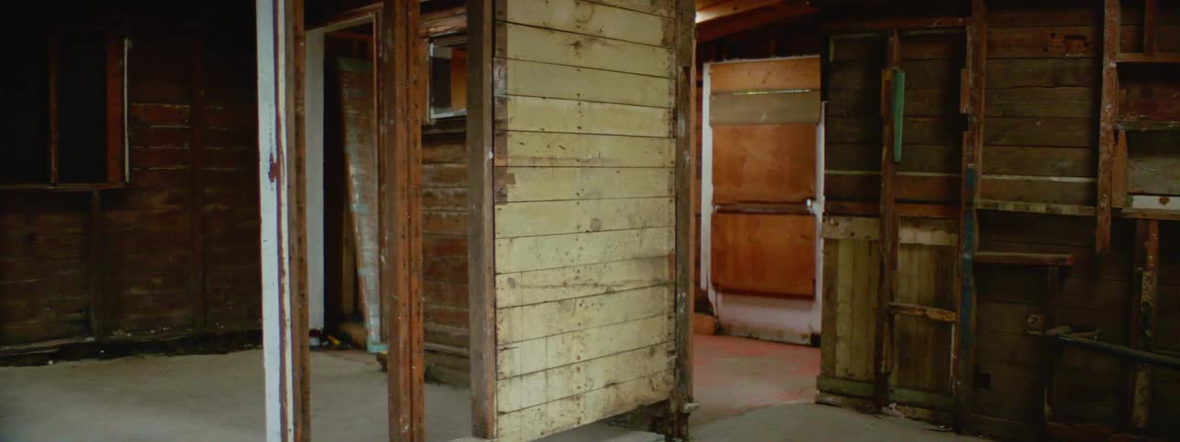 Bare interior wood walls of an empty brick house