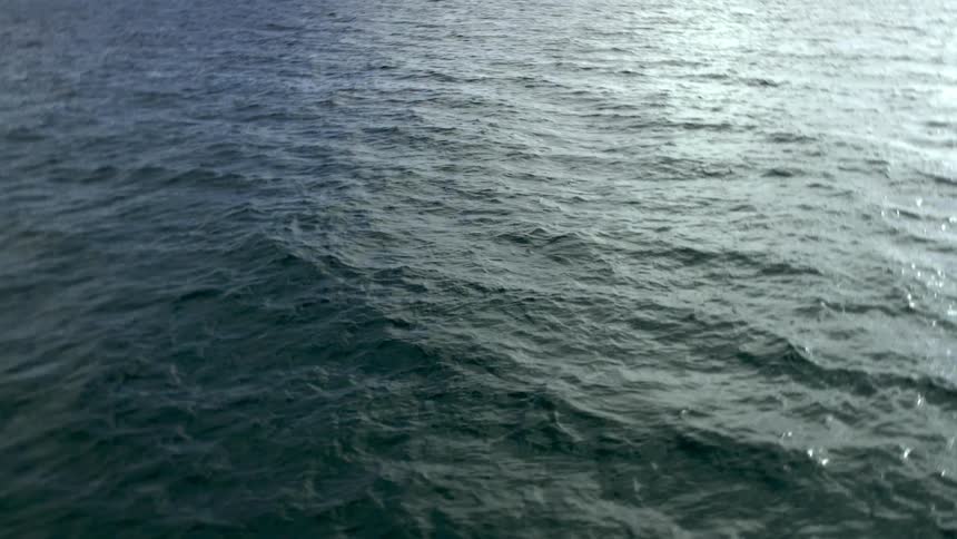 A static aerial view of waves rippling along sea water