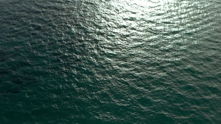 Aerial view of the sun shining on body of water