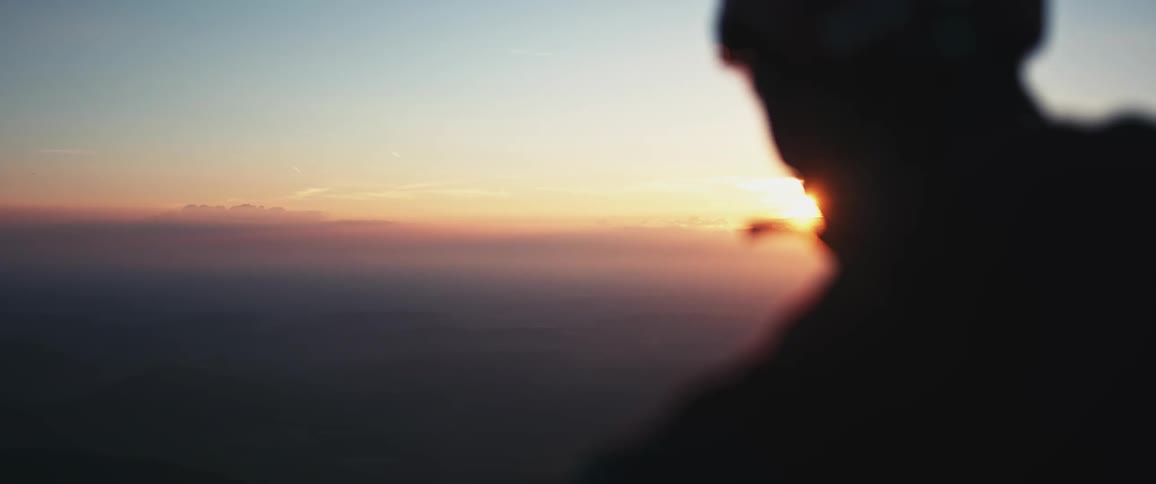 The view is of a man looking at the view of the ocean