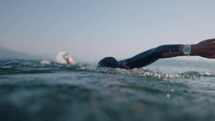 The view is of a young woman that is swimming outdoors
