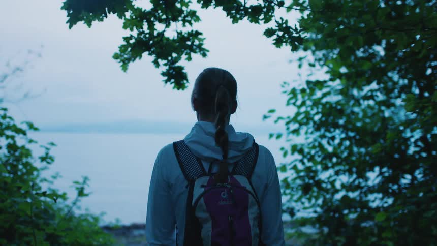The view is of a kid walking outside in the day time